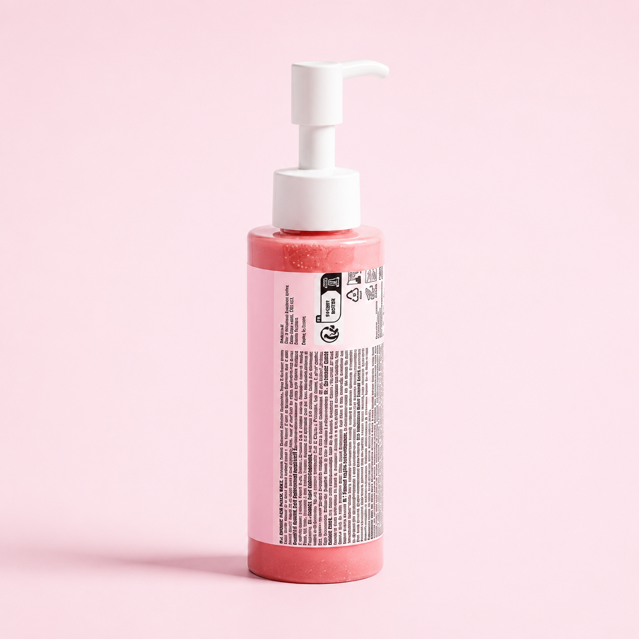 A bottle of pink cosmetic cream or gel with a white pump dispenser, shown from the back against a solid light pink background.