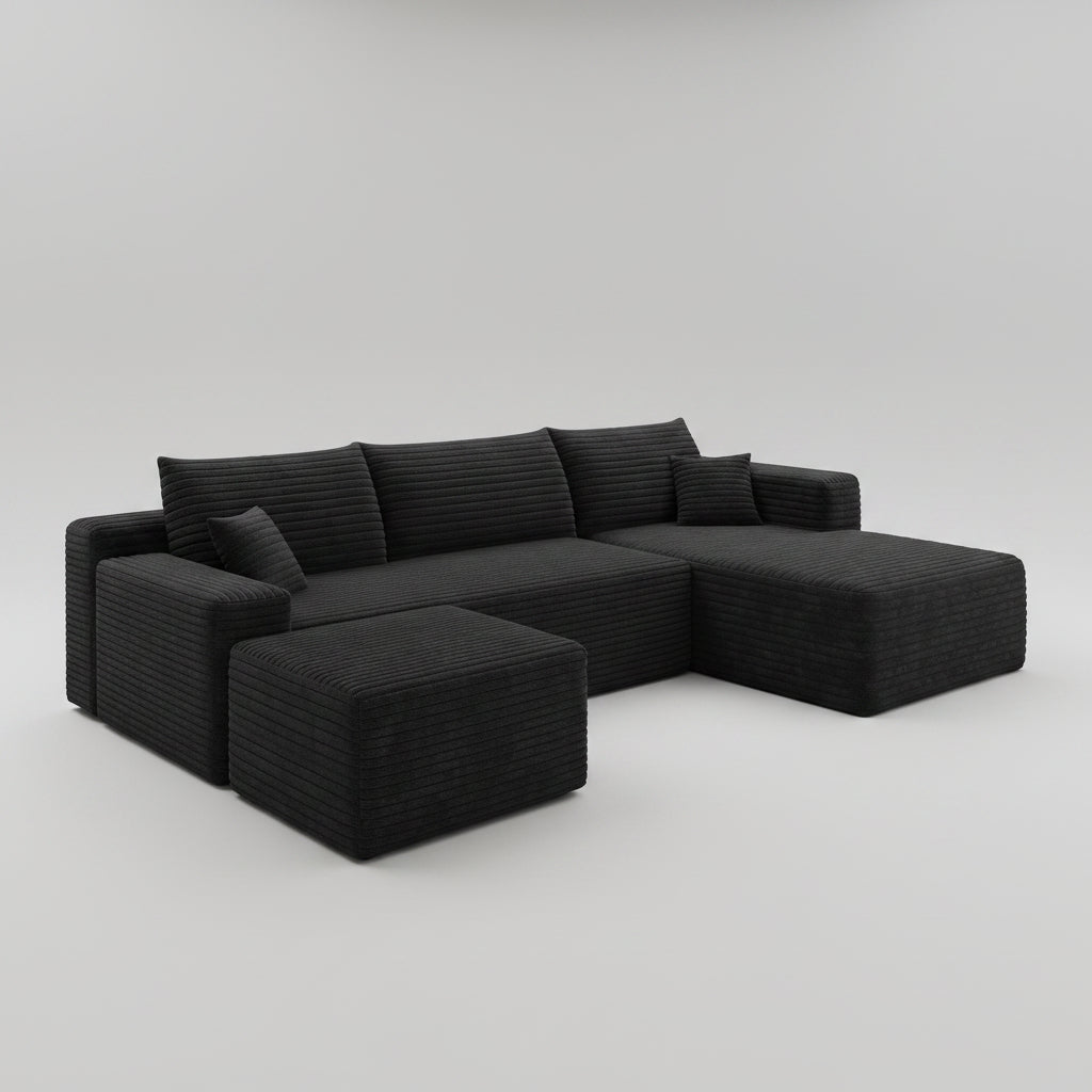 Woman reading a book on a black sectional sofa in a modern living room.