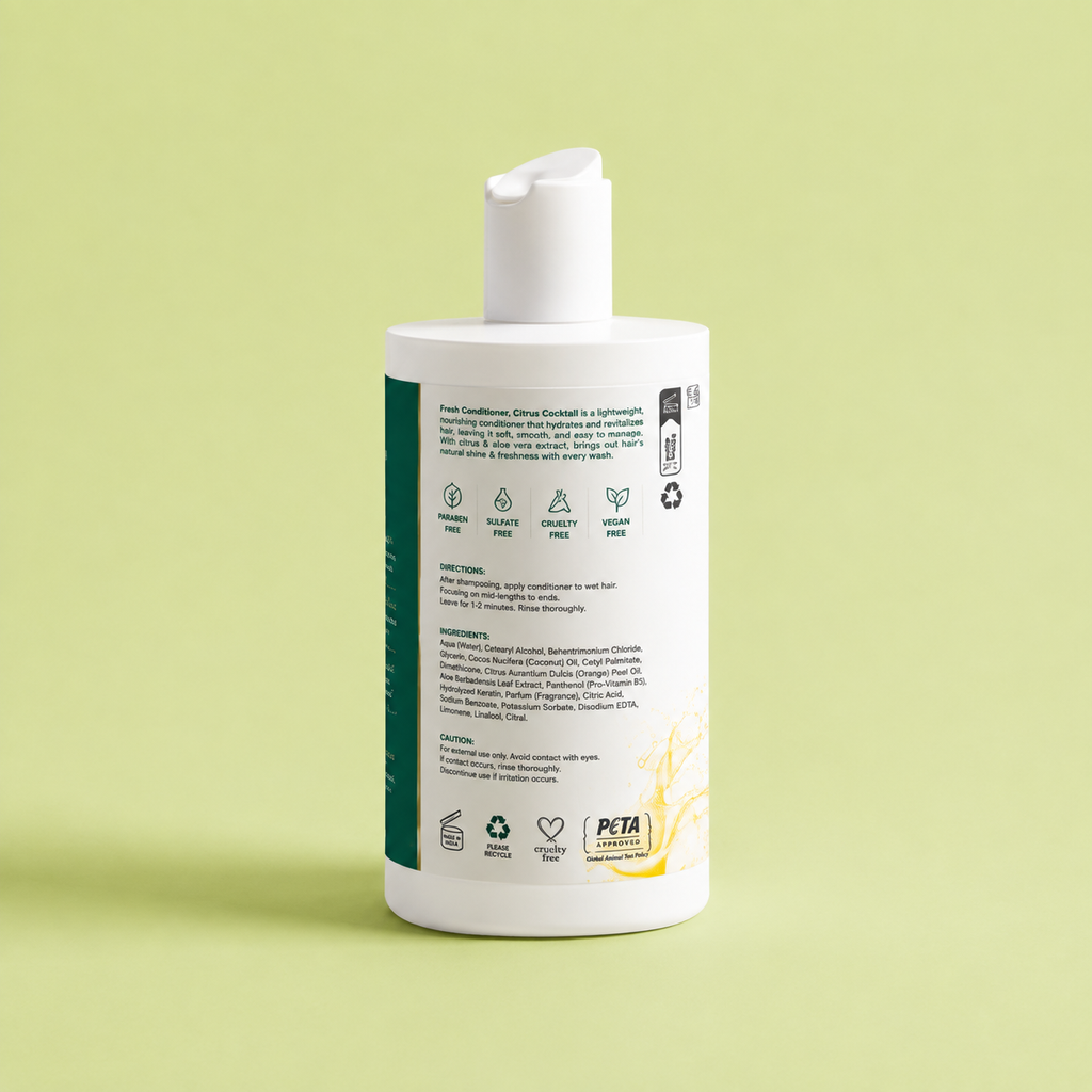 A white pump bottle of Clère Scandal Fresh Conditioner, showing the back label with text and icons, set against a solid pale green background.