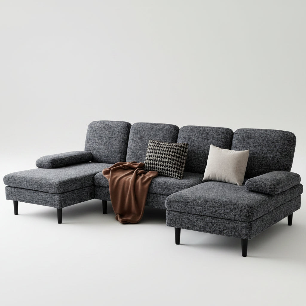 Gray sectional sofa in a living room with decorative pillows and a patterned rug.