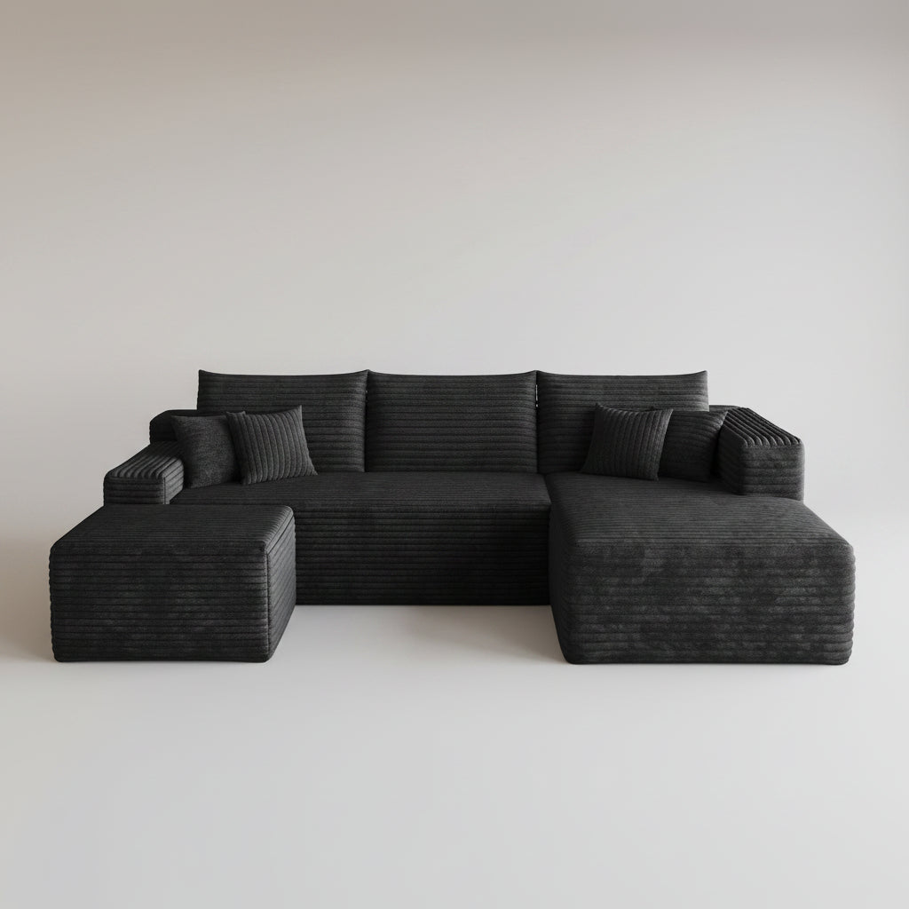 Woman reading a book on a modern black sofa in a stylish living room.