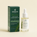 Gold-X Skin Rosemary Hair & Scalp Strengthening Oil shown with its dark green packaging box and a clear glass dropper bottle containing the oil, set against a solid cream background.