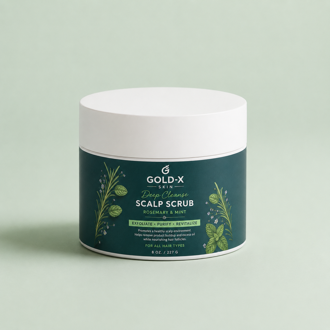 A jar of Gold-X Skin Scalp Scrub with a dark green label and white lid, set against a solid pale green background.