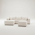 Modern living room with a white sectional sofa, round rug, and decorative plants.