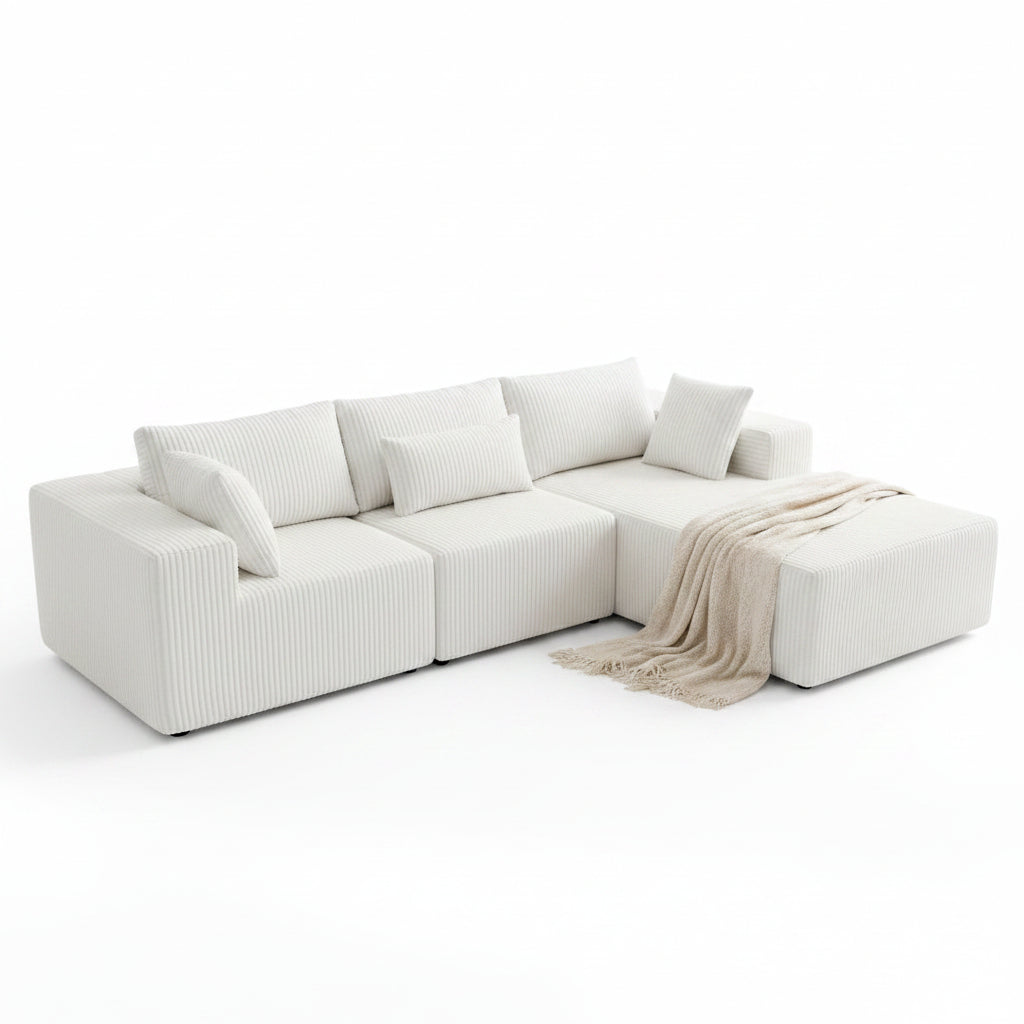 Family sitting on a dark blue sectional sofa in a bright living room.